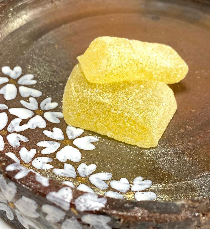 Yellow TSUYAMAYA SEIKA Pururi Yuzu & Honey Kanten Jelly on decorative ceramic plate.