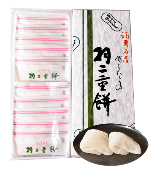 Box of Habutae Mochi with soft plain rice cakes on a black plate, showcasing traditional Japanese packaging and dessert.