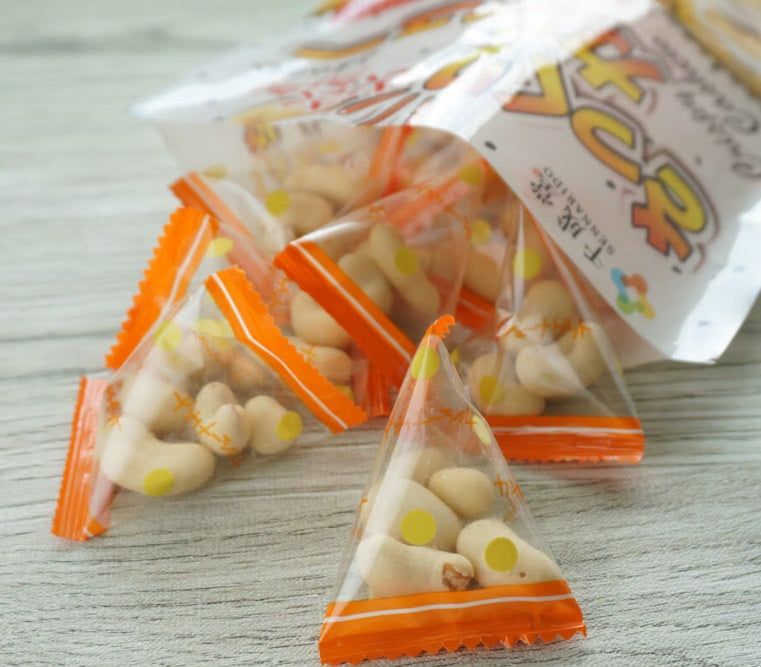 Pack of cashew nuts snack with 80g sealed in individual orange triangle packs, showcasing soft, crispy, sweet, and salty flavors.