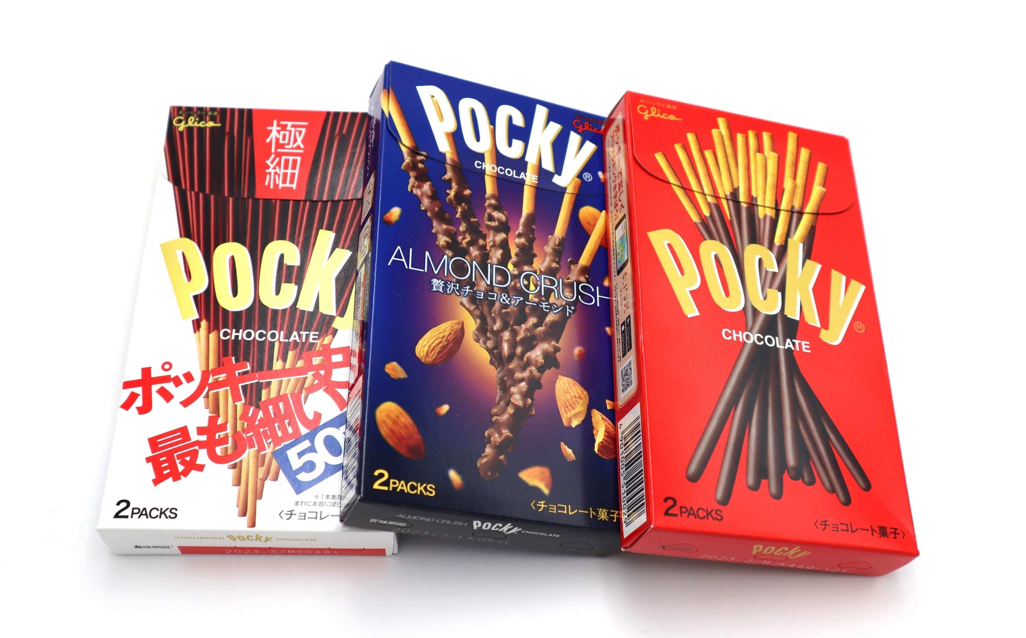 Boxes of Pocky regional flavors, featuring Almond Crush and classic chocolate, highlighting unique Japanese taste variations.