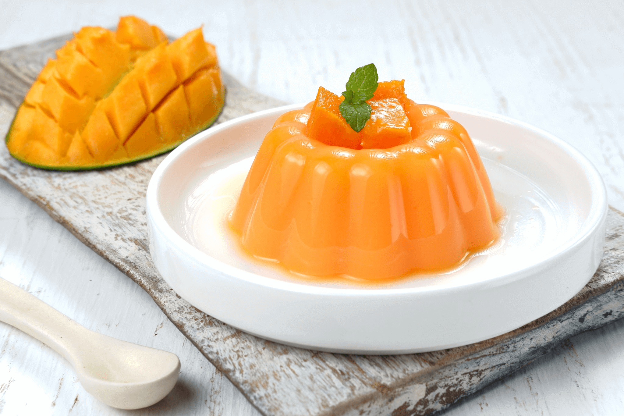 Mango-flavored Konnyaku Jelly with fresh fruit garnish for a healthy, low-calorie snack on a white plate.
