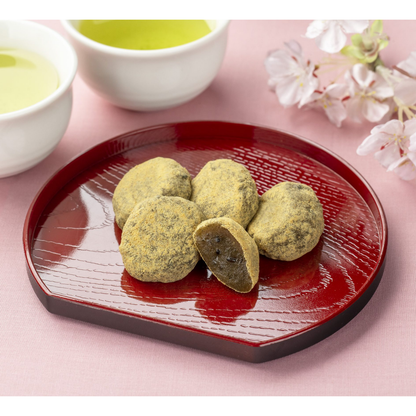 Japanese black sesame kinako mochi on a lacquered plate, soft chewy mochi coated with roasted soybean powder