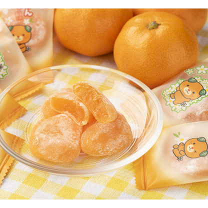 Mikan mochi, soft chewy Japanese rice cake candy with sweet citrus flavor and powdered sugar coating